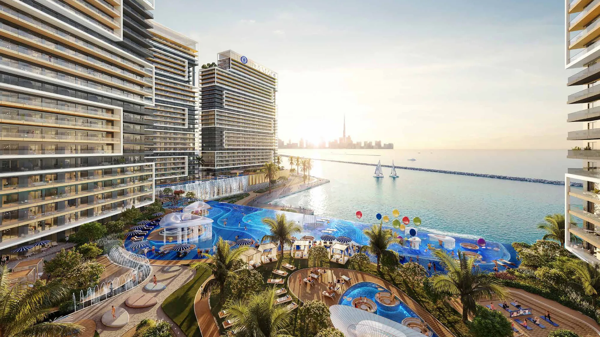 Pool deck between the towers, sea and Dubai skyline at sunrise