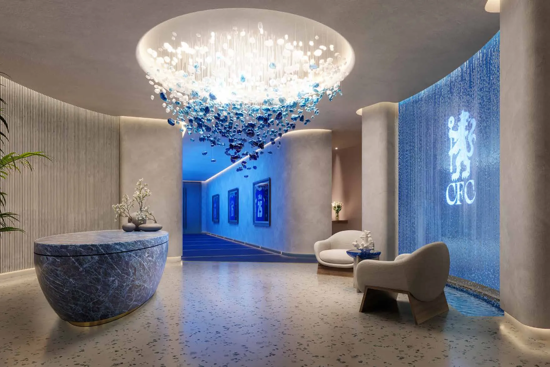 Spa reception with glass chandelier and a blue water wall
