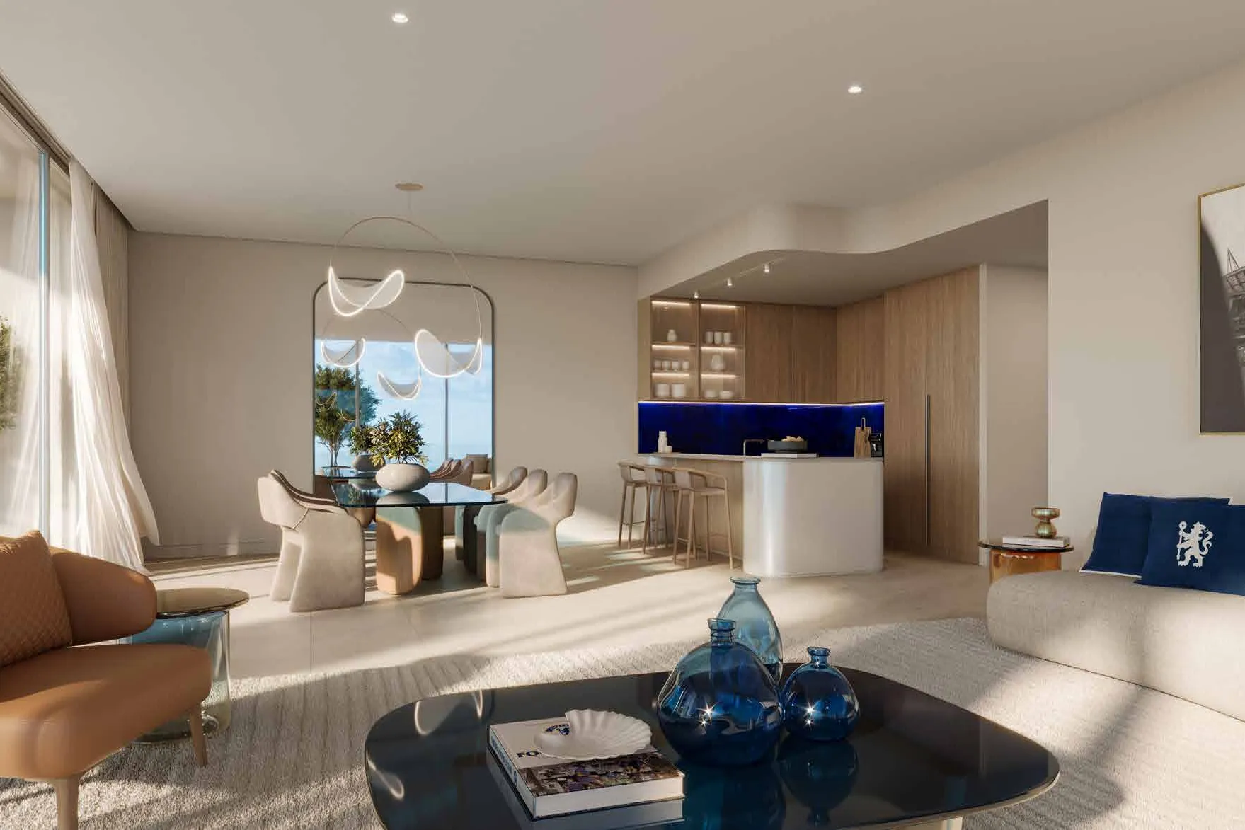 Living room opening to a kitchen with blue splashback and dining table