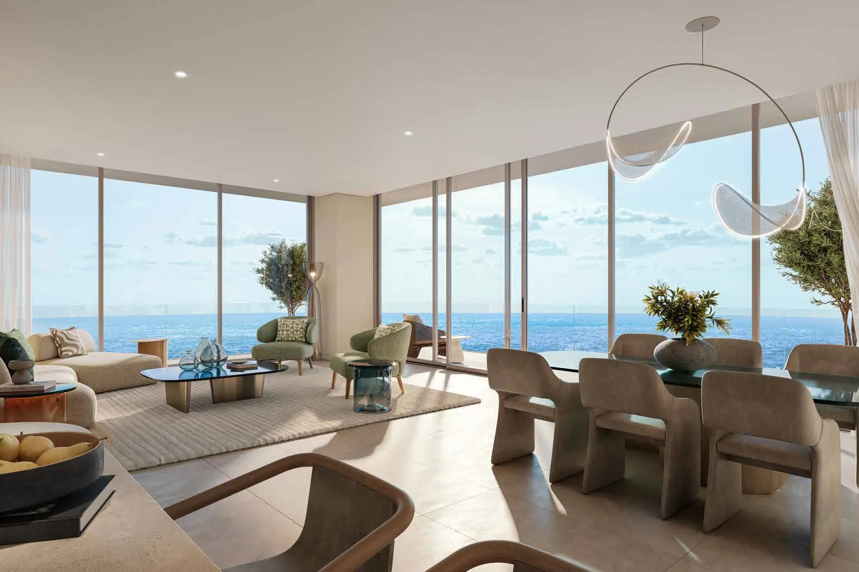 Open living and dining room with floor-to-ceiling windows onto the sea