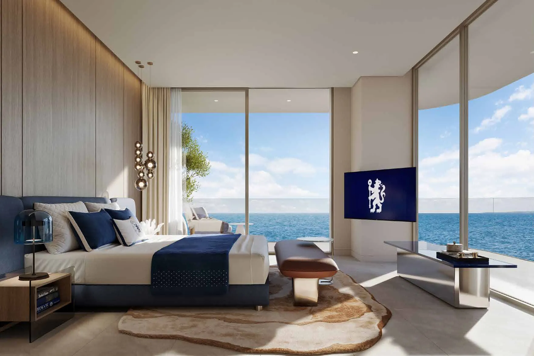 Bedroom with navy bed, corner windows and wide sea view